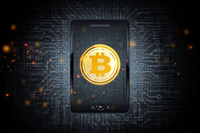 Smartphone displaying Bitcoin symbol on circuit board background