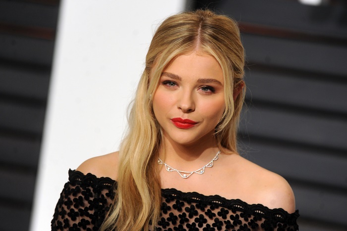 Chloë Grace Moretz wearing a black off-the-shoulder dress and necklace