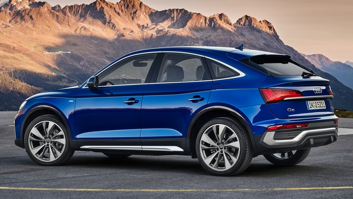 Blue Audi Q5 Sportback S Line parked with mountains in background