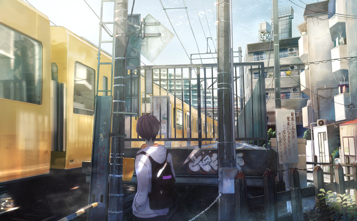 Boy with backpack at train station