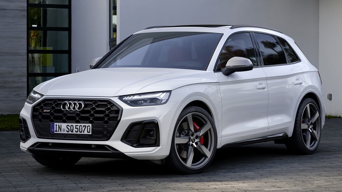 White Audi SQ5 parked in front of a modern building