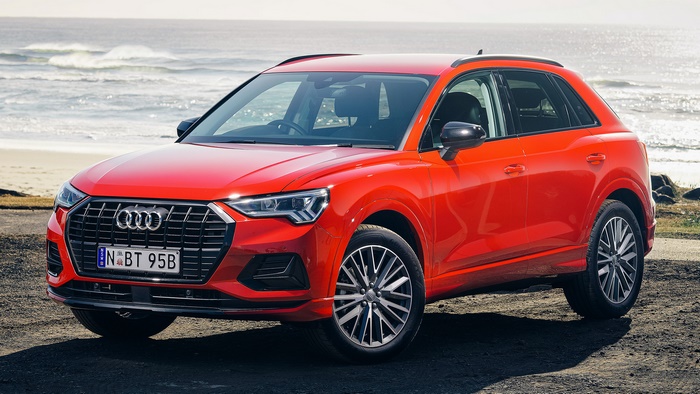 Red Audi Q3 SUV parked on a beach