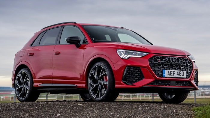 Red Audi RS Q3 parked on gravel