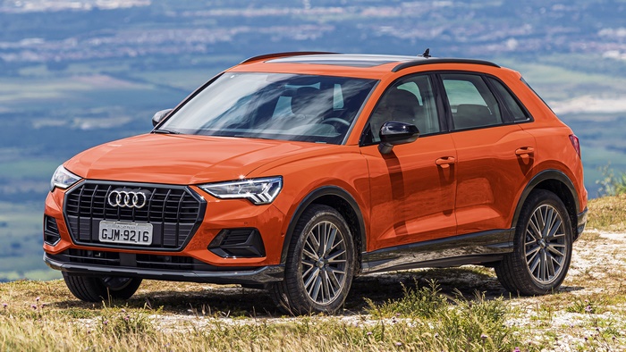 Orange 2019 Audi Q3 SUV parked on a hill