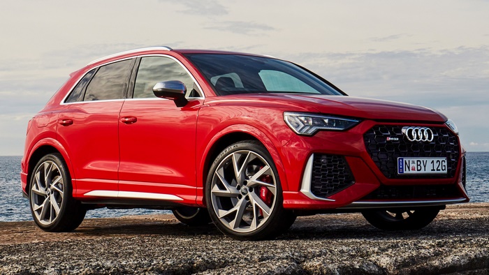 Red Audi RS Q3 parked by the sea