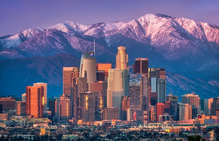 Los Angeles skyline with snow-capped mountains