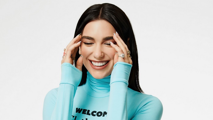 Dua Lipa wearing a blue turtleneck shirt