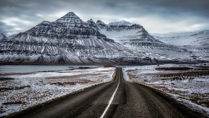 Road leading to snow-covered mountains in Iceland 4K