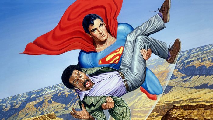 Superman carrying Richard Pryor over a canyon
