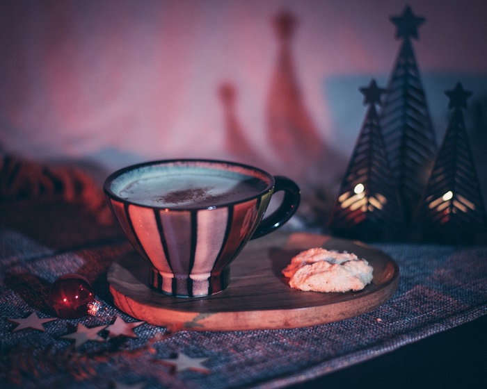 Hot chocolate in a striped cup with a cookie