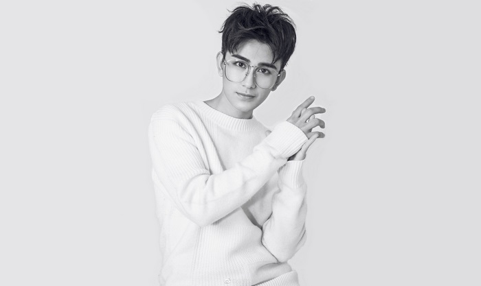 Zhu Zanjin wearing glasses and a sweater