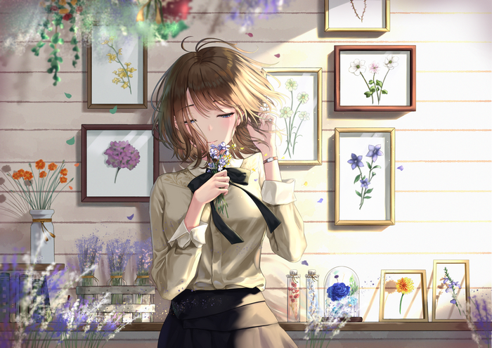 Girl with brown short hair smelling flowers