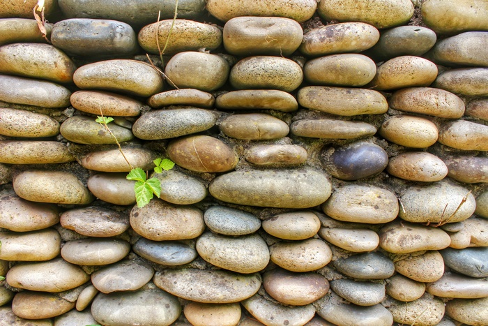 Wall of rounded river stones