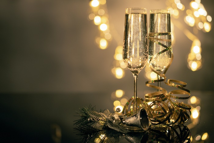 Champagne glasses with Christmas decorations and bokeh lights
