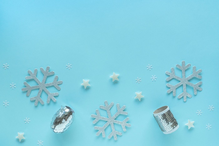 Silver snowflakes and stars on a blue background
