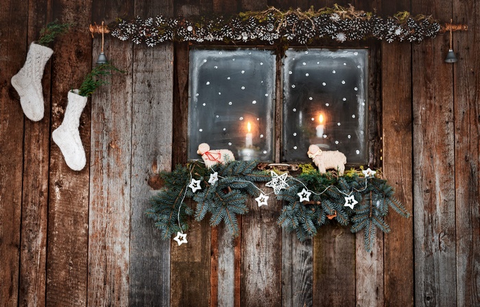 Christmas window decoration with candles and stockings