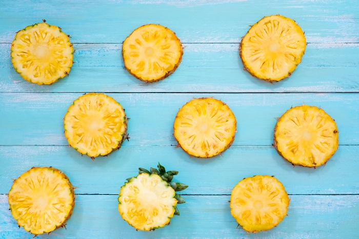 Pineapple slices on blue wooden background