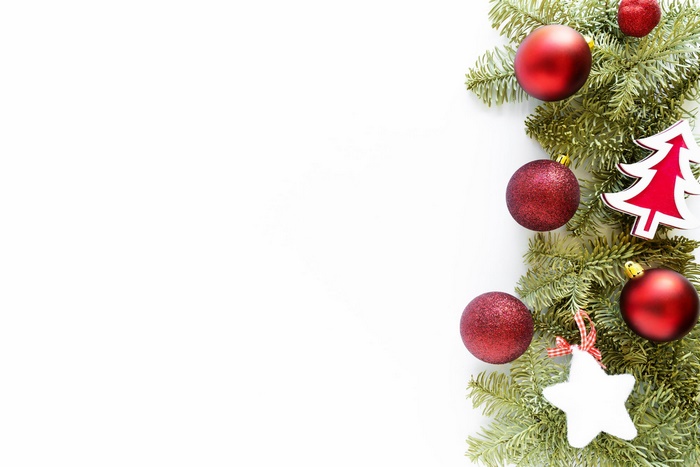 Christmas tree branch with red baubles and ornaments