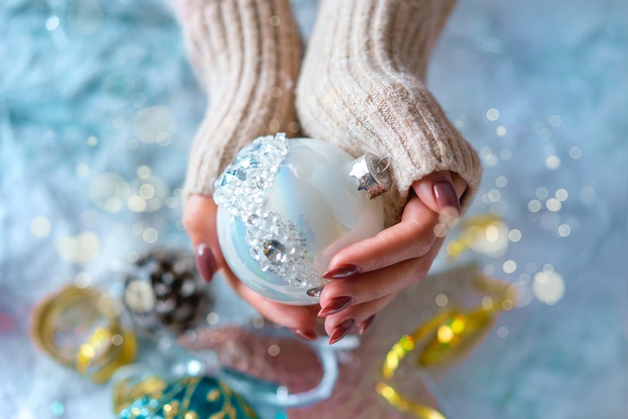 Hands holding a Christmas ornament