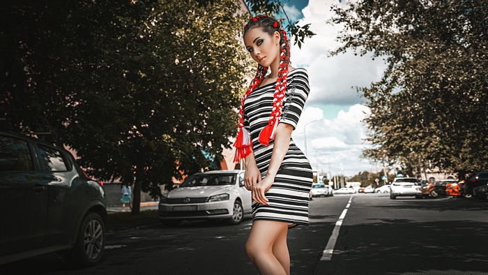 Woman with pigtails in striped dress on street