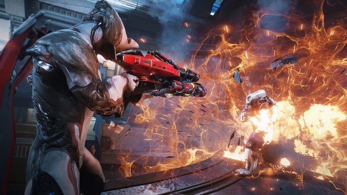 Warframe character firing a red weapon amidst an explosion