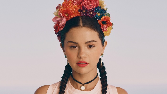 Selena Gomez wearing a floral wreath and braids