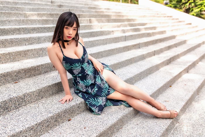 Asian Woman in Floral Dress Sitting on Stairs