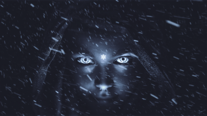 Surreal portrait of a woman with glowing eyes in snow