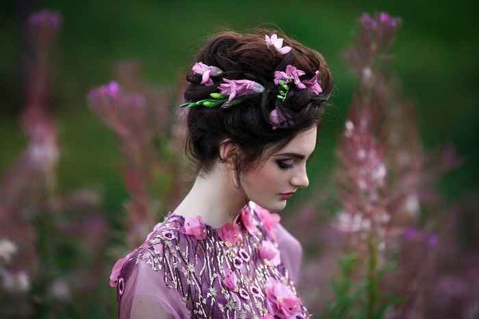 Woman with flowers in her hair and a purple dress