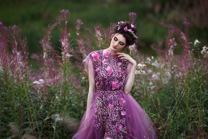 Model in a floral purple dress in a field