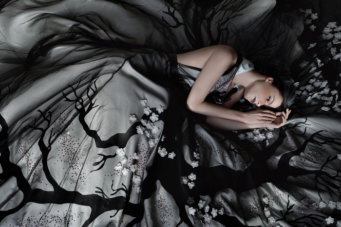 Model in a black and white floral dress