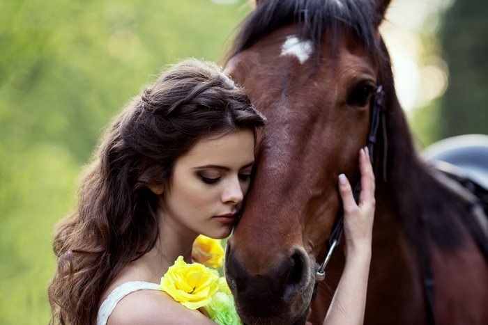 Woman with horse and yellow roses