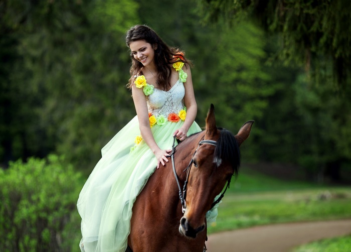 Woman in a dress riding a horse