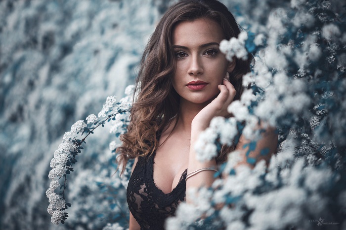 Model Posing Among White Blossoms