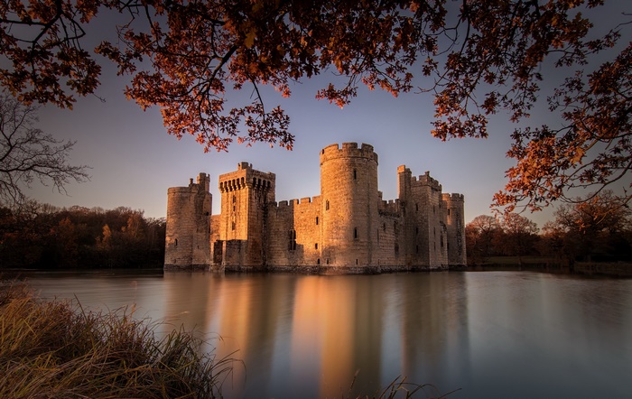 Bodiam Castle reflected in the lake during autumn