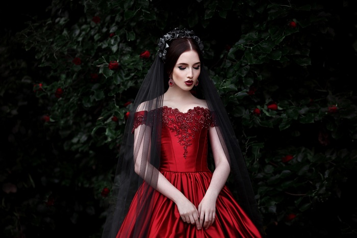 Woman in red dress with black veil