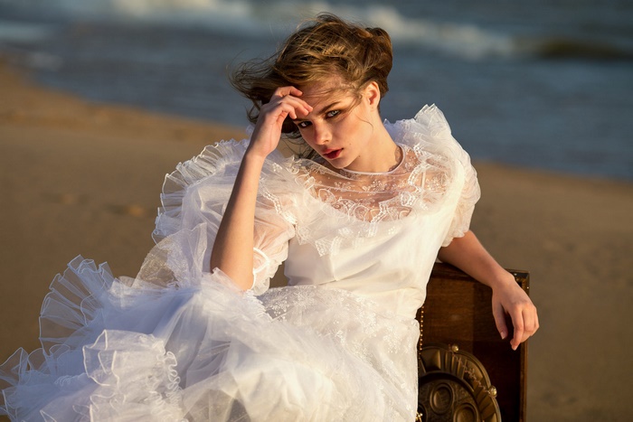 Woman in white dress on a beach