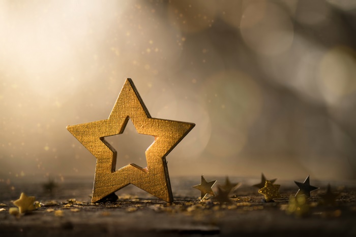 Golden Stars on Wooden Surface 4K