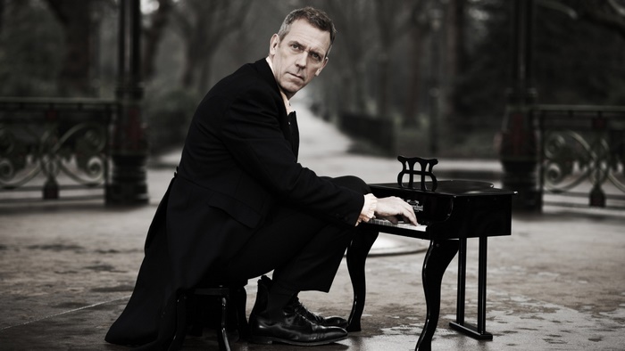 Hugh Laurie playing a small piano