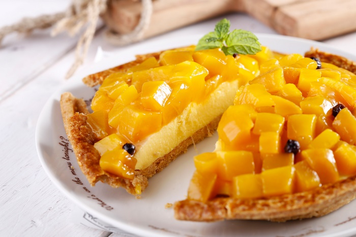 Mango fruit tart with mint garnish