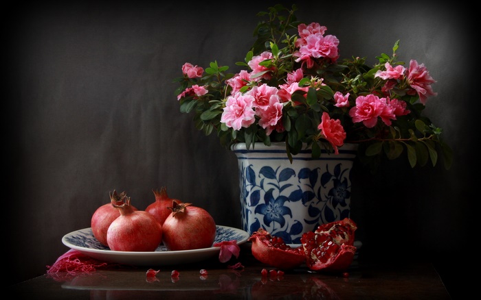 Still life with pomegranates and pink azaleas in a blue and white pot
