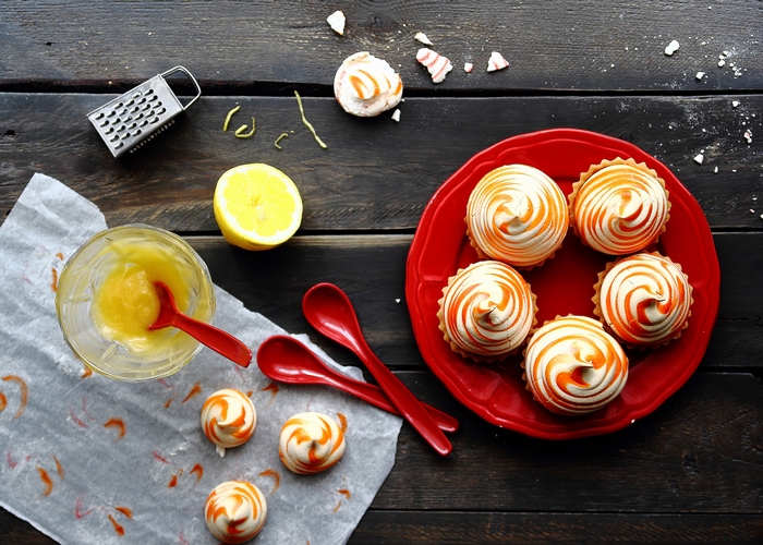 Lemon Meringue Tarts and Ingredients on Wooden Table