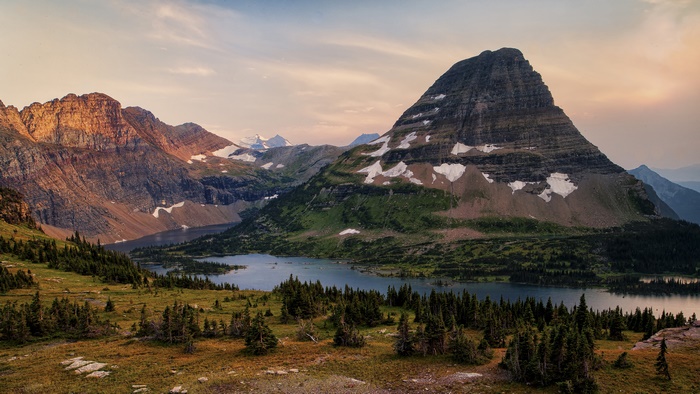 Mountain lake with rocky peaks and spruce trees