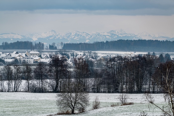 Village and snow-covered mountains in winter