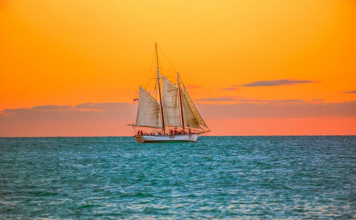 Sailboat on the ocean at sunset