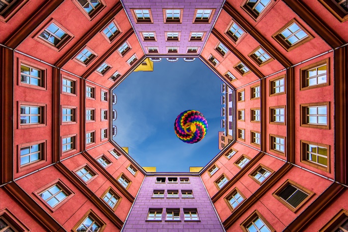Hot air balloon over buildings