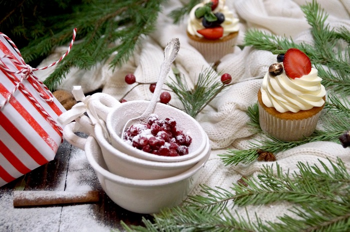 Christmas cupcakes with berries and gift