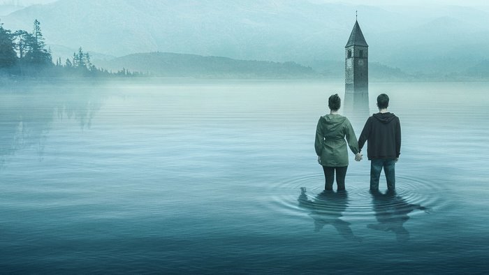 Couple holding hands in submerged church lake