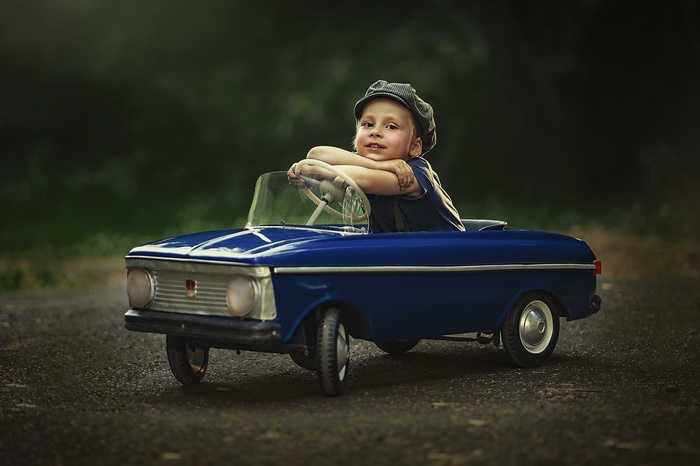 Boy in a toy car