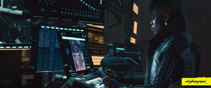Woman in a dark room using computers in Cyberpunk 2077